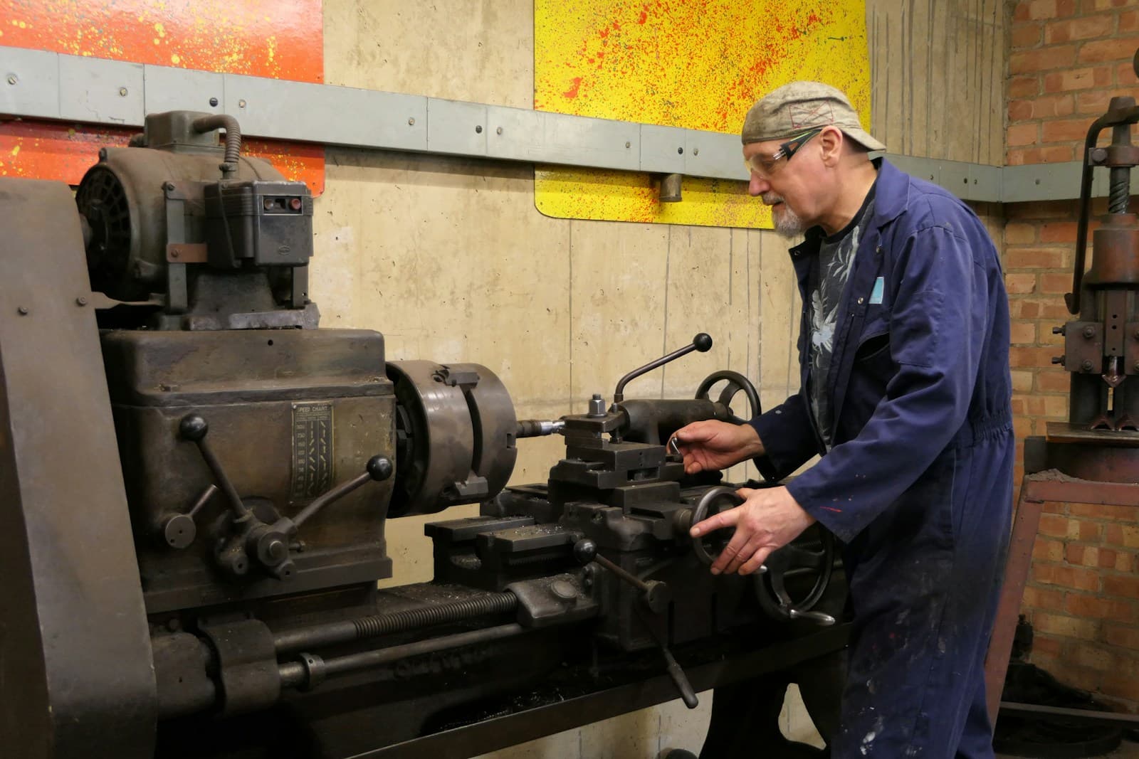 A machine operator at a workshop lathe