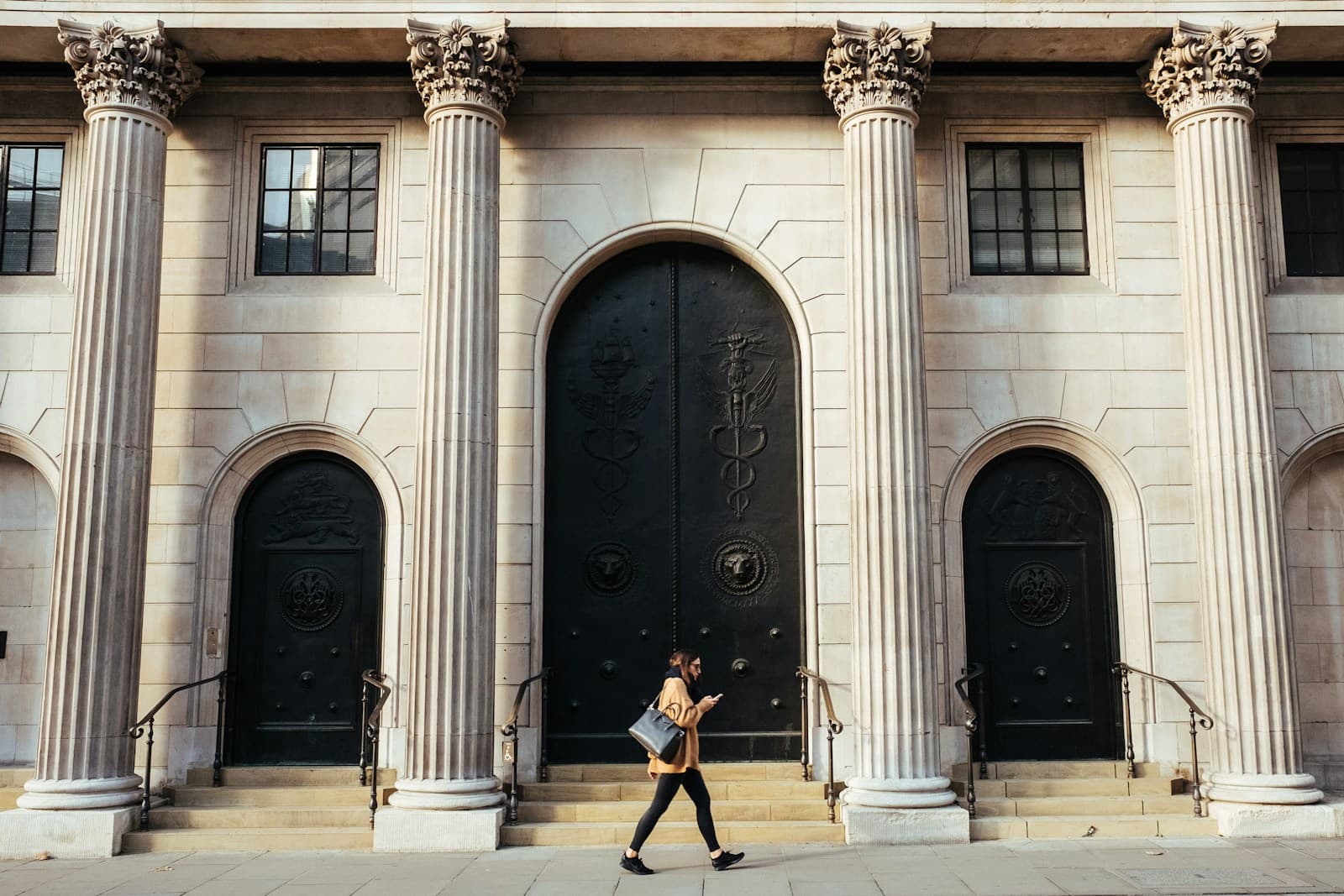 The columned stone facade and bronze doors of a bank