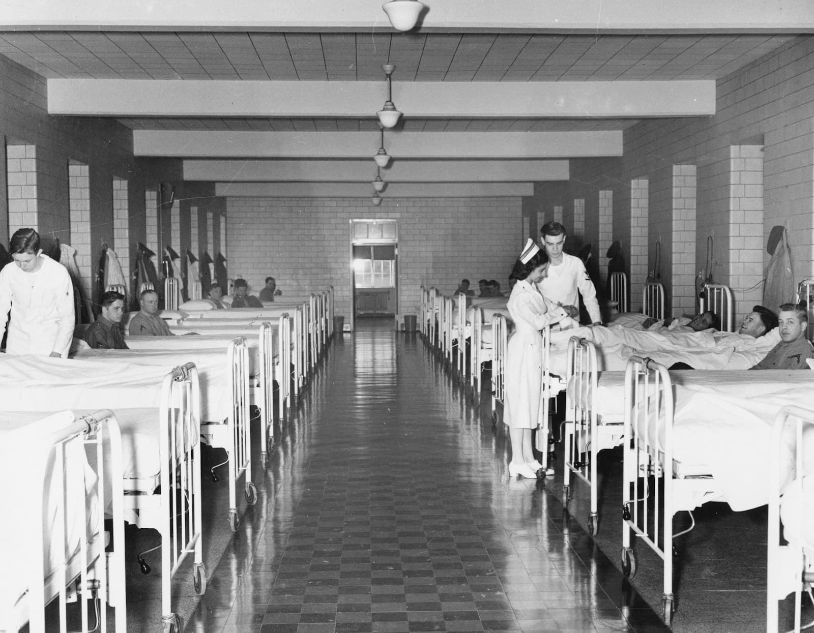 Nurses attending to patients on a hospital ward