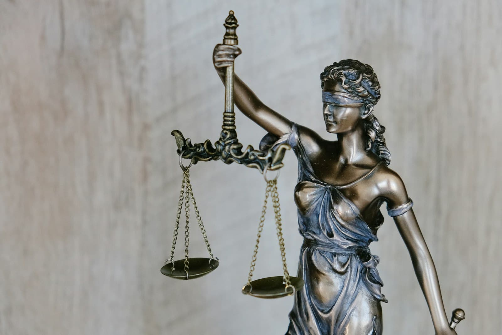 A bronze statue of Lady Justice holding her scales